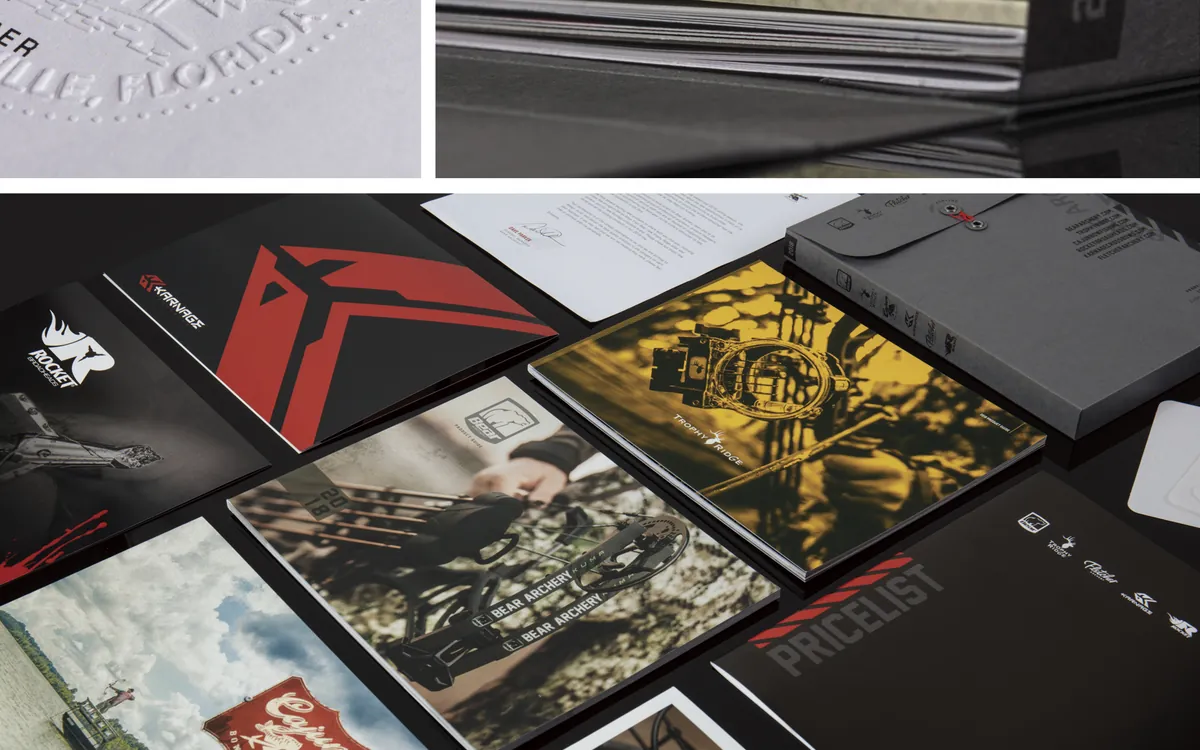 Pages and covers from the 2018 Archery Master Catalog Kit laid out on a table